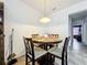 Dining room with tile floors, a round table, four chairs, and pendant lighting at 236 Barrington Dr, Haines City, FL 33844