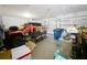 Spacious three car garage with ATV, trailer, a yellow pickup truck, and storage at 236 Barrington Dr, Haines City, FL 33844