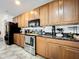 Kitchen with stainless steel appliances and light wood cabinetry and granite countertops at 236 Barrington Dr, Haines City, FL 33844