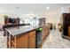 View of kitchen island with granite countertops, with kitchen and living area in the background at 236 Barrington Dr, Haines City, FL 33844