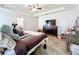 Comfortable primary bedroom featuring tray ceiling, tile floors, and neutral color scheme at 236 Barrington Dr, Haines City, FL 33844