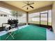 Enclosed patio includes a ceiling fan, a grill and an outdoor chair set for entertaining at 236 Barrington Dr, Haines City, FL 33844