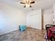 Bright room with tile floors, ceiling fan, closet, and blue bench at 236 Barrington Dr, Haines City, FL 33844