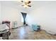 Bright room with tile floors, ceiling fan, gray curtains, and medical equipment at 236 Barrington Dr, Haines City, FL 33844