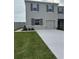 Two-story home featuring gray siding, neat landscaping, a one-car garage, and gray shutters at 3337 Private Oak Dr, Apopka, FL 32703