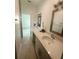 Bright bathroom featuring a double sink vanity with white cabinets and modern fixtures at 388 Chinaberry Ave, Oviedo, FL 32765
