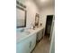 Bright bathroom featuring a double sink vanity with white cabinets and modern fixtures at 388 Chinaberry Ave, Oviedo, FL 32765