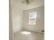 Bright, minimalist bedroom with a ceiling fan and a window overlooking the backyard at 388 Chinaberry Ave, Oviedo, FL 32765