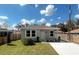 Charming single-story home with a well-manicured lawn, bright white trim, and a paved driveway at 388 Chinaberry Ave, Oviedo, FL 32765