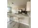 Stylish kitchen featuring stainless steel appliances, an island with bar stools, and modern lighting at 388 Chinaberry Ave, Oviedo, FL 32765