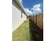 Grassy side yard featuring a well-kept lawn and a sturdy wooden fence for added privacy at 388 Chinaberry Ave, Oviedo, FL 32765