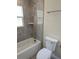 Bathroom with tile shower, granite vanity, and toilet at 6929 Central Ave, Mulberry, FL 33860