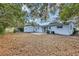 Wide view of the backyard, including the shed, patio, and lush trees at 707 Beverly Ave, Altamonte Springs, FL 32701