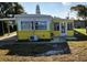 Yellow single-wide mobile home with carport and small yard at 1417 Highland Ave, Tavares, FL 32778