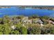 Stunning aerial view of waterfront homes featuring lush landscaping, private pools, and access to a beautiful lake at 2032 Dumas Dr, Deltona, FL 32738