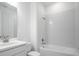 This bathroom features a combination shower and bathtub, single sink vanity and chrome fixtures at 4723 Coral Harbour Rd, Kissimmee, FL 34758