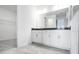 Modern bathroom with double vanity, sleek cabinets, and tile flooring at 4723 Coral Harbour Rd, Kissimmee, FL 34758