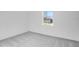 This bedroom features neutral carpeting, bright, neutral paint and a large window at 4723 Coral Harbour Rd, Kissimmee, FL 34758