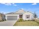 Single-story home with gray siding, brick red door, matching shutters, manicured lawn, and a two-car garage at 4723 Coral Harbour Rd, Kissimmee, FL 34758