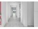 This hallway features ceramic tiling and neutral paint and leads to a lake view at 4723 Coral Harbour Rd, Kissimmee, FL 34758