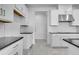 Bright kitchen showcases white cabinets and tile backsplash with stainless steel appliances and black countertops at 4723 Coral Harbour Rd, Kissimmee, FL 34758