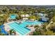An amazing community pool and amenities area with beach volleyball, a slide, and lounge chairs at 8279 Nemours Pkwy, Orlando, FL 32827