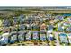 Aerial view of a beautiful blue two-story home in a well-maintained neighborhood, offering serene lake views at 8279 Nemours Pkwy, Orlando, FL 32827