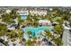 Fantastic view of the community pool, which has different pool styles, lounge chairs, and palm trees at 8279 Nemours Pkwy, Orlando, FL 32827