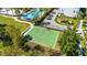 The community features a basketball court with green surface, black fencing, and manicured landscaping at 8279 Nemours Pkwy, Orlando, FL 32827