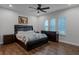 Primary bedroom featuring wood floors, a ceiling fan, and natural light from large windows at 8279 Nemours Pkwy, Orlando, FL 32827