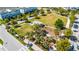 Aerial view of a lush community park featuring a playground, picnic shelter, and expansive green space at 8279 Nemours Pkwy, Orlando, FL 32827