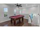 Upstairs game room featuring hardwood floors, natural light, and a beautiful pool table at 8279 Nemours Pkwy, Orlando, FL 32827