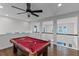 Upstairs game room showcasing hardwood floors, natural light, and a view of the neighborhood at 8279 Nemours Pkwy, Orlando, FL 32827