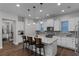 Modern kitchen featuring white cabinets, granite countertops, pendant lighting, and stainless appliances at 8279 Nemours Pkwy, Orlando, FL 32827