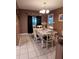 Charming dining room with a table set for four and updated lighting at 910 Rangeline Rd, Longwood, FL 32750