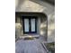 Modern double front doors with a pebble stone entryway at 910 Rangeline Rd, Longwood, FL 32750