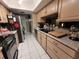 Galley kitchen with stainless steel appliances and granite countertops at 910 Rangeline Rd, Longwood, FL 32750
