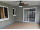 Screened porch with tile flooring and ceiling fan at 910 Rangeline Rd, Longwood, FL 32750