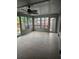 Bright sunroom with new flooring, ceiling fan, and access to backyard at 910 Rangeline Rd, Longwood, FL 32750