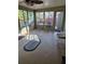 Sunroom features new flooring, a ceiling fan, and a small seating area at 910 Rangeline Rd, Longwood, FL 32750