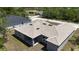 Overhead view of the tan-roofed home, highlighting the backyard and surrounding neighborhood at 1202 Alafia Way, Poinciana, FL 34759