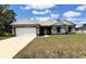 Charming single-story home with a two-car garage and well-maintained front lawn at 1202 Alafia Way, Poinciana, FL 34759