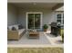 Relaxing covered patio with comfortable seating and grill, perfect for outdoor entertaining and enjoying the backyard at 1202 Alafia Way, Poinciana, FL 34759