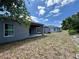 Large backyard featuring a covered patio on a sunny day at 1314 Hillsborough Ct, Poinciana, FL 34759