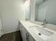 Double sink bathroom vanity with quartz countertop and sleek modern fixtures at 1314 Hillsborough Ct, Poinciana, FL 34759