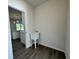 Clean utility room with white sink, gray flooring, and convenient access to the kitchen at 1314 Hillsborough Ct, Poinciana, FL 34759