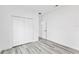 Clean and bright bedroom with gray wood-look flooring, showcasing a spacious closet at 3041 Sw 168Th Loop, Ocala, FL 34473