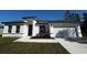 Single-story home features a well-manicured lawn, bright white exterior, and a driveway at 3041 Sw 168Th Loop, Ocala, FL 34473