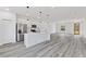 Modern kitchen featuring white cabinets, stainless steel appliances, and a stylish island with pendant lighting at 3041 Sw 168Th Loop, Ocala, FL 34473