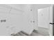 Bright laundry room features a utility sink, storage, shelving and access to other areas in the home at 3041 Sw 168Th Loop, Ocala, FL 34473